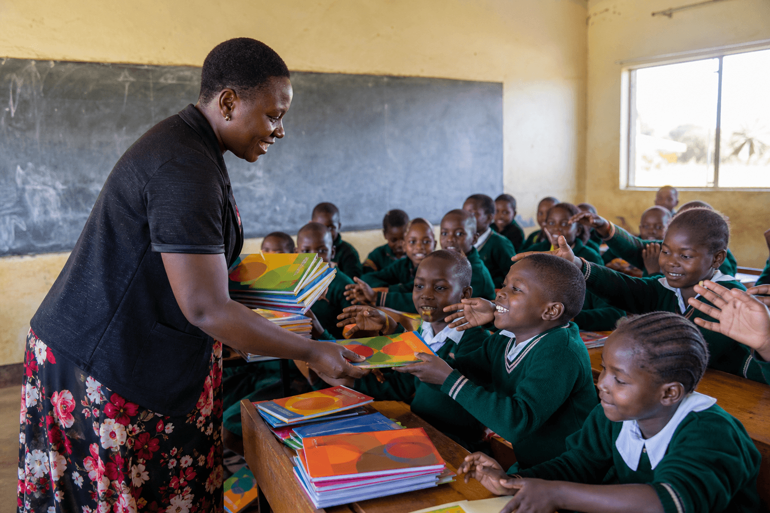 A press operator checking freshly printed school books at a Nairobi printing works